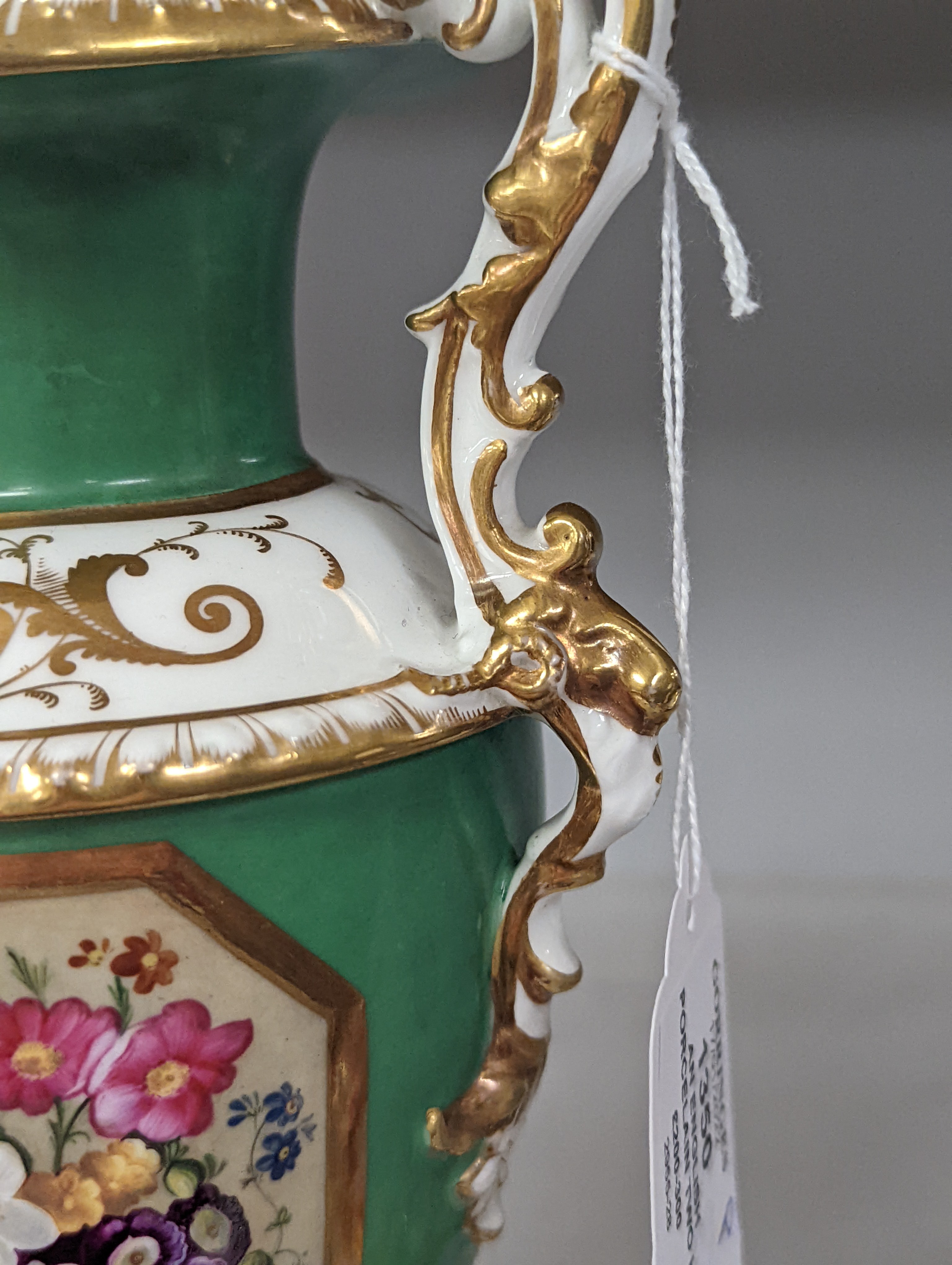 An English porcelain two handled vase painted with flowers in a panel on a green ground, probably Grainger Worcester, c.1830, height 24cm